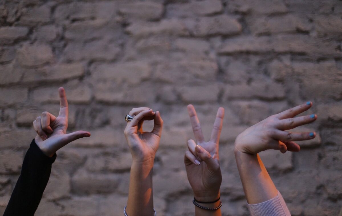 LOVE spelled out with hand signals.